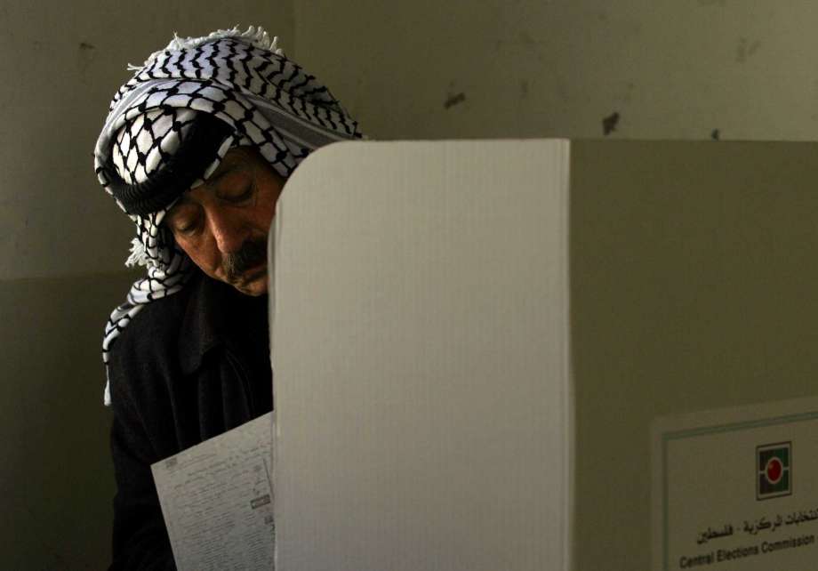 Palestinian police officer fills in his ballot before casting it in parliamentary elections in the West Bank city of Nablus. Palestinian President Mahmoud Abbas's Fatah party says the Palestinian high court has