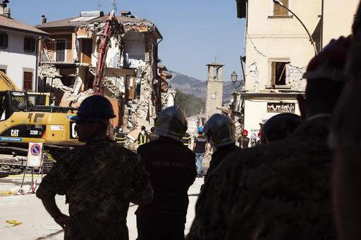 Bulldozers work to clear out Italy's quake-hit towns