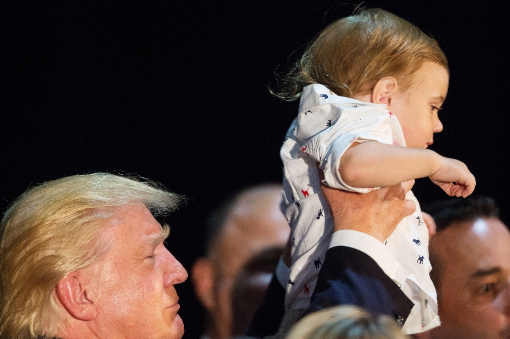 TRUMP CHILD CARE 4-8 Republican presidential nominee Donald Trump holds up Tristan Murphy 1 after discussing his child care proposals at a campaign event in Aston Pa. Mr. Trump in a speech called for six weeks of mandatory paid maternity leave and expa