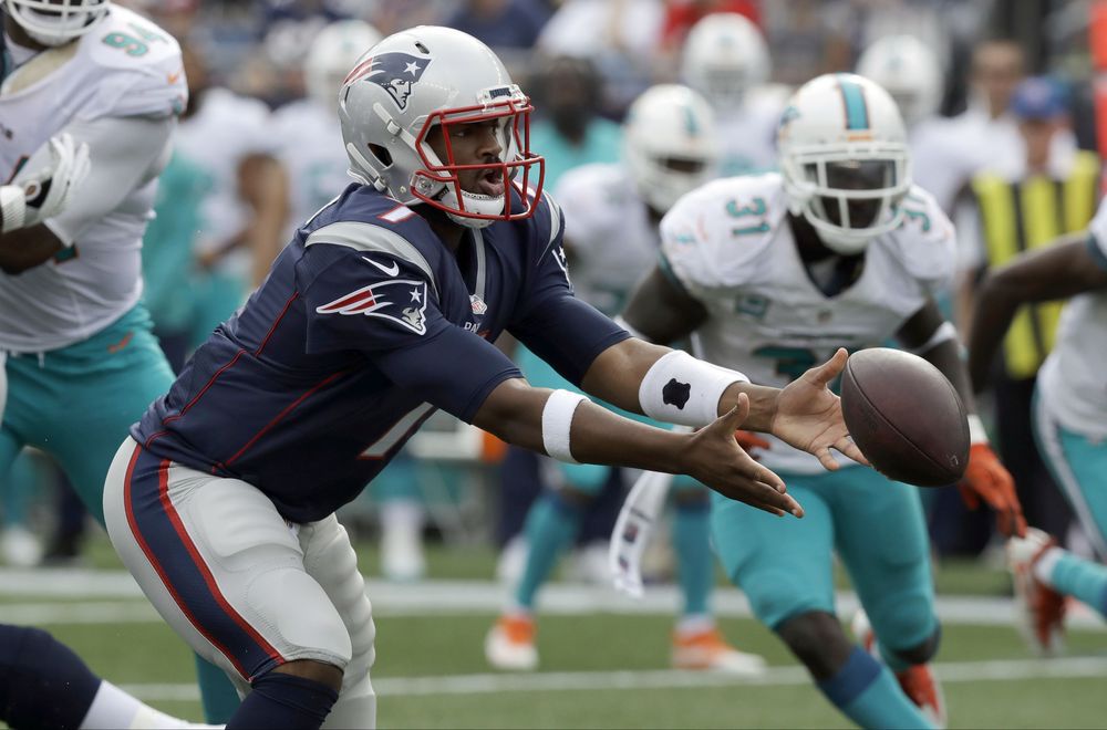 New England Patriots quarterback Jacoby Brissett pitches the ball in front of Miami Dolphins safety Michael Thomas during the second half of an NFL football game in Foxborough Mass. Two months