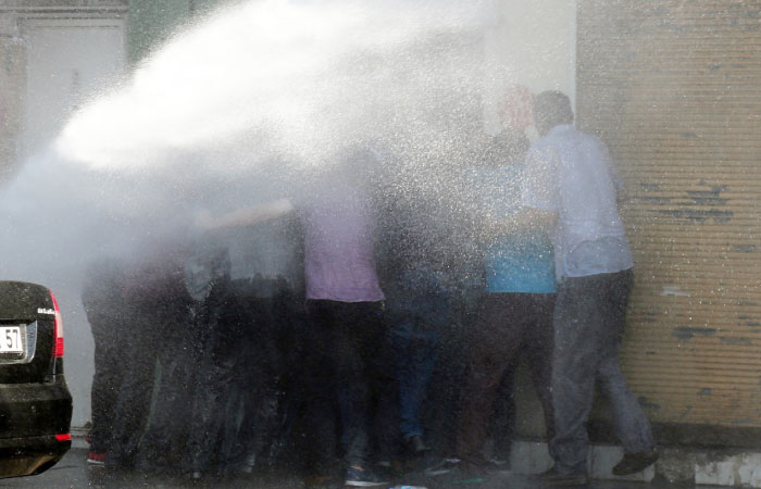 Turkish riot police use water cannon to disperse Kurdish demonstrators protesting against the removal of the local mayor from office over suspected links with Kurdish militants in Diyarbakir Turkey. — Reuters