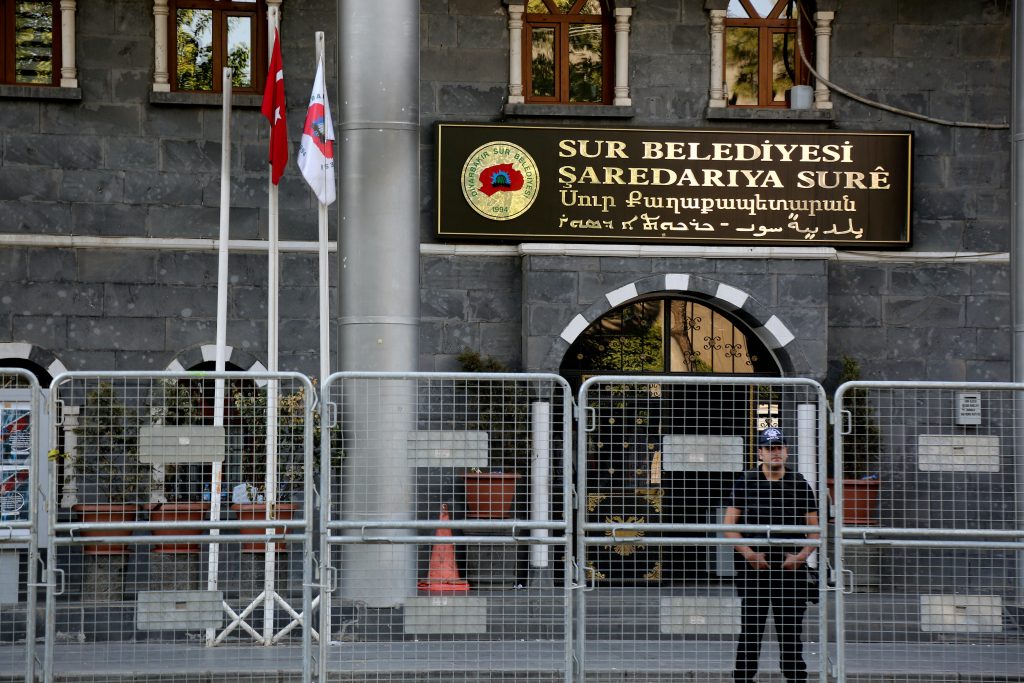 A riot police officer stands guard in front of Sur municipality office following the removal of the local mayor from office after he was deemed to support Kurdish militants in Diyarbakir Turkey