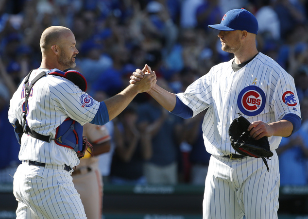 Chicago Cubs starter Jon Lester right celebrates with catcher David Ross after they defeated the San Francisco Giants in a baseball game Friday Sept. 2 2