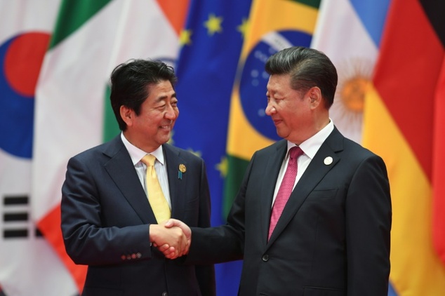 Japan's Prime Minister Shinzo Abe shakes hands with China's President Xi Jinping in Hangzhou China