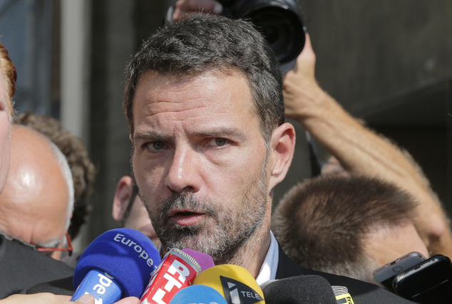 Former trader Jerome Kerviel speaks to the media at the Versailles appeal court west of Paris Friday Sept. 23 2016. A French court has cut the civil dama