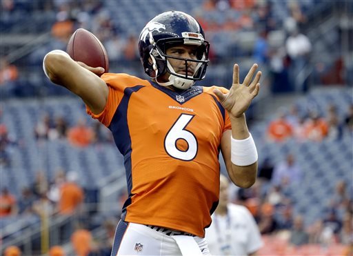 Denver Broncos quarterback Mark Sanchez warms up before an NFL preseason football game against the Los Angeles Rams in Denver. A person with knowledge of the deal says the Dallas Cowboys have agreed