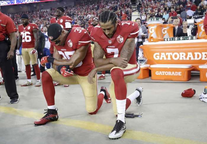 Niners quarterback Colin Kaepernick and safety Eric Reid kneel during the national anthem before last Monday night's game against the Rams in Santa Clara Calif. Associated Press