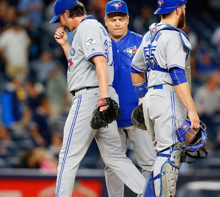 PItcher Jason Grilli #37 of the Toronto Blue Jays leaves the game in the eighth inning against the New York Yankees as manager John Gibbons #5 and teammate Russell Martin #55 look on at Yankee Stadium