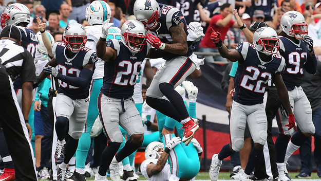 The New England Patriots celebrate after recovering a fumble by Jarvis Landry #14 of the Miami Dolphins during the second quarter at Gillette Stadium