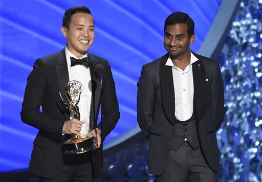 Kelvin Yu left and Aziz Ansari accept the award for outstanding writing for a comedy series for Master of None at the 68th Primetime Emmy Awards on Sunday Sept. 18 2016 at the Microsoft Theater in Los Angeles