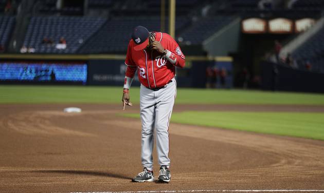 Washington Nationals manager Dusty Baker inspects the field during a rain delay in the seventh inning of a baseball game against the Atlanta Braves in Atlanta Sunday Sept. 18 2016