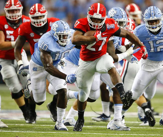 John Bazemore  Associated Press Georgia running back Nick Chubb tries to breaks away from North Carolina linebacker Andre Smith