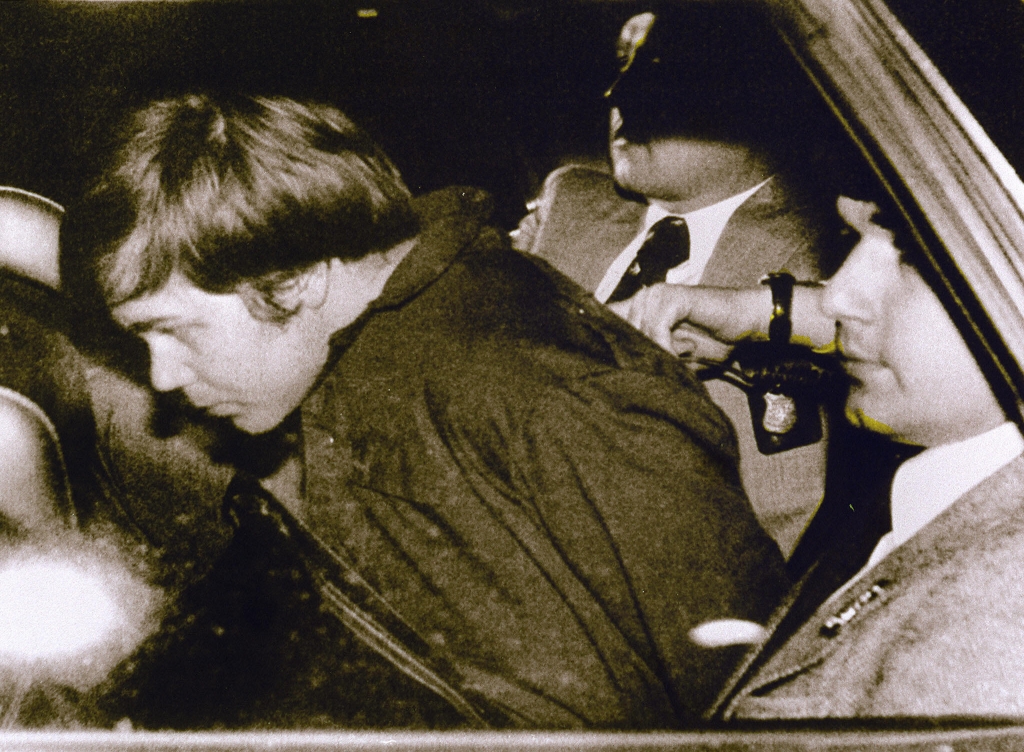 Jr. escorted by police in Washington DC following his arrest after shooting and seriously wounding then US president Ronald Reagan. A federal judge ruled 17 Dece