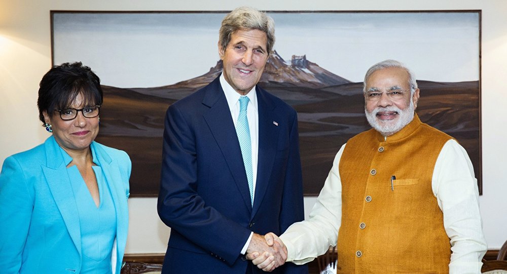 U.S. Secretary of State John Kerry shakes hands with Indian Prime Minister Narendra Modi and U.S. Secretary of Commerce Penny Pritzker stand by their sides at Modi's residence in New Delhi India Friday Aug. 1 2014