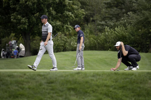 Dustin Johnson right Roberto Castro center and Paul Casey look over the putting green on the seventh hole during the third round of the BMW Championship golf tournament at Crooked Stick Golf Club in Carmel Ind. Saturday Sept