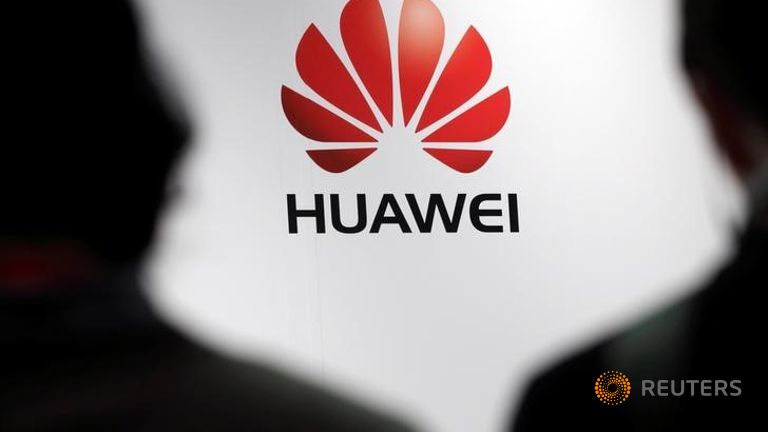 Journalists attend the presentation of the Huawei's new smartphone in Paris