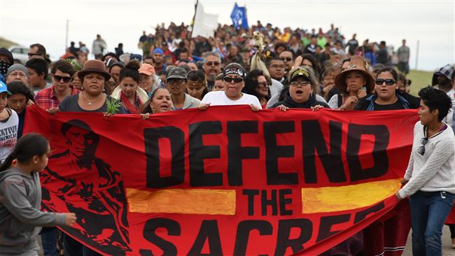 Native Americans march to a burial ground sacred site that was disturbed by bulldozers building the Dakota Access Pipeline, near the encampment where hundreds of people have gathered to join the Standing Rock Sioux Tribe