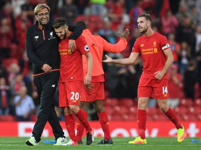 Jurgen Klopp celebrates on the pitch at Anfield in Liverpool England