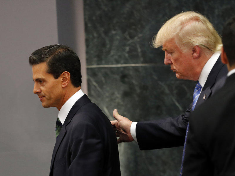 Republican presidential nominee Donald Trump walks with Mexico President Enrique Peña Nieto at the end of their joint statement at Los Pinos the presidential residence in Mexico City