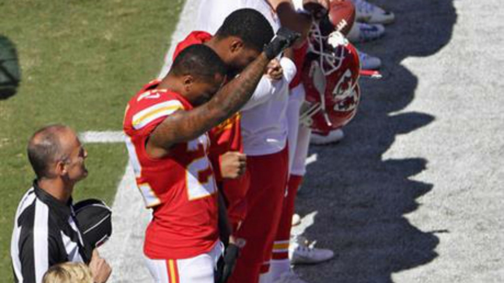 Kansas City Chiefs cornerback Marcus Peters raises his fist in the air during the national anthem before an NFL football game against the San Diego Chargers on Sunday Sept. 11 2016 in Kansas City Mo