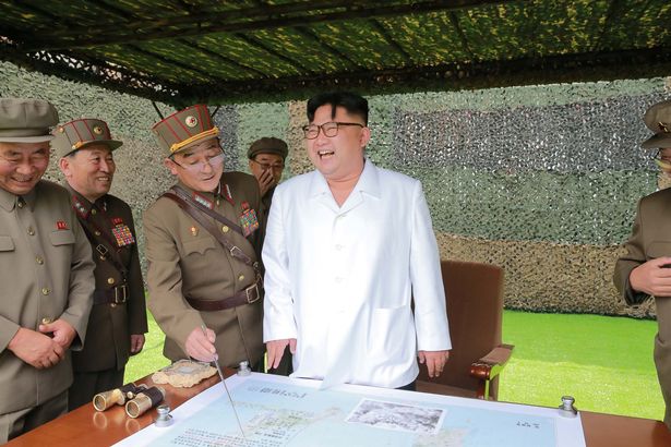 North Korean leader Kim Jong Un provides field guidance during a fire drill of ballistic rockets