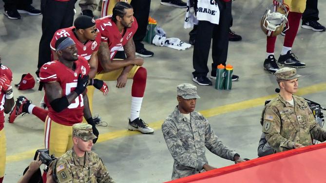 Kaepernick and Reid kneel before their first game of the year.                     USATSI