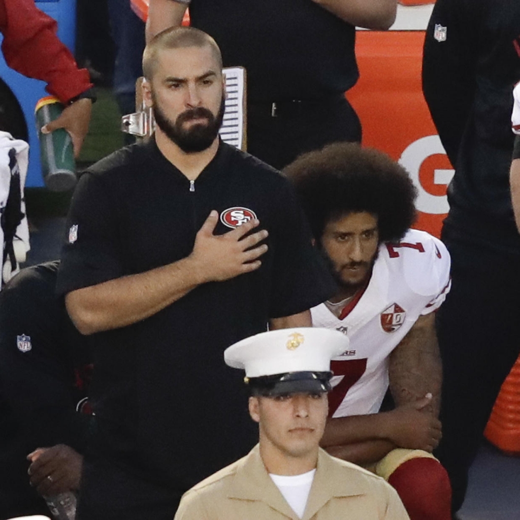 Colin Kaepernick quarterback of the San Francisco 49ers kneels during the national anthem before Thursday night's game in San Diego