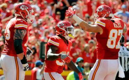 Kansas City Chiefs tight end Travis Kelce greets running back Spencer Ware after Ware scored a touchdown during the second half of an NFL football game against the San Diego Chargers in Kansas City Mo. Sunday Sept. 11 2016. (AP