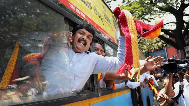 Police take away Kannada activists in a bus as they were trying to enter the Railway Station to stop trains during their protest over Cauvery water issue in Bengaluru