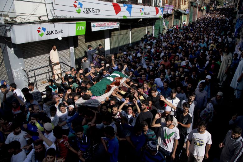 Kashmiri Muslims shout freedom slogans as they carry the body of Nasir Shafi during his funeral procession on Saturday