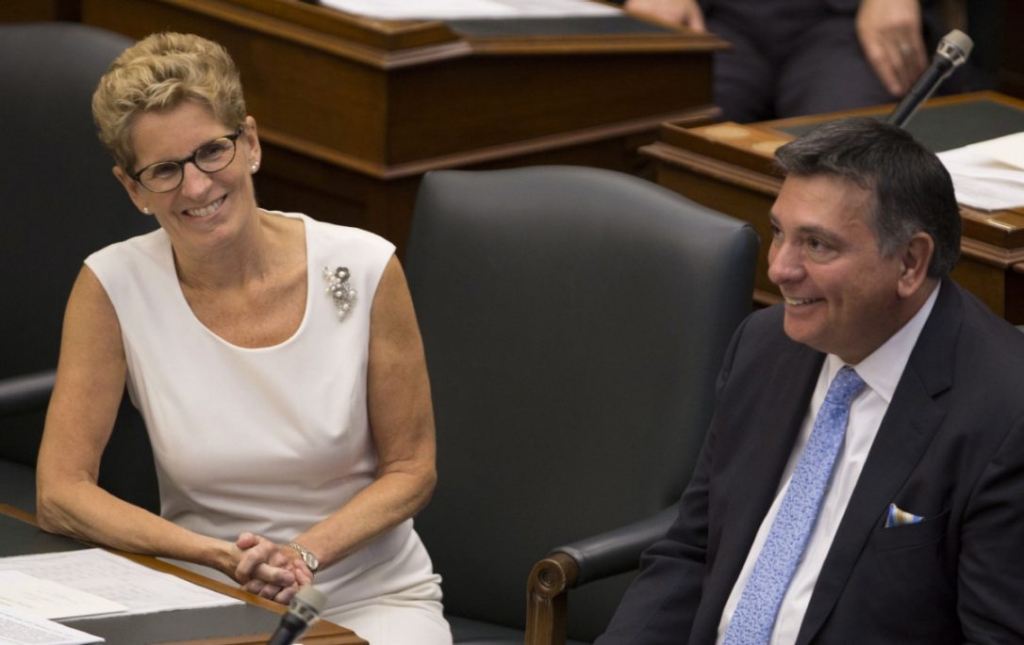 Ontario Premier Kathleen Wynne and Finance Minister Charles Sousa smile following the speech from the throne opening the second session of the 41st Parliament of Ontario