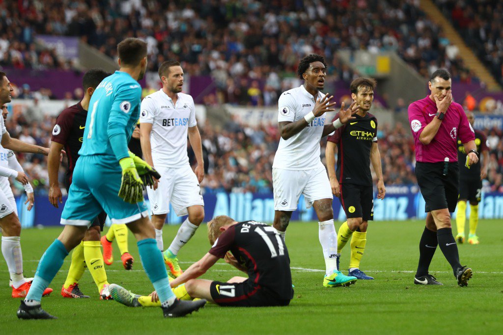 SWANSEA WALES- SEPTEMBER 24 Leroy Fer of Swansea City argues with referee Neil Swarbrick after he awarded Manchester City a penalty for a foul on Kevin De Bruyne of Manchester City during the Premier League match between Swansea City and Manchester