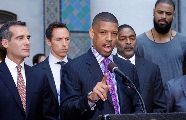 Former NBA player Kevin Johnson tackles and punches protester who threw pie on his face