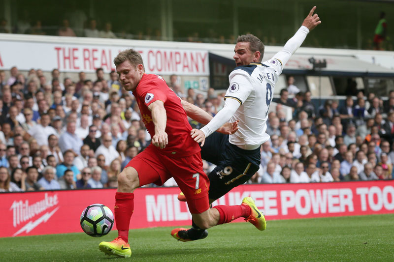 Liverpool's James Milner beats Tottenham's Vincent Janssen to the ball during the English Premier League football match between Tottenham Hotspur and Liverpool at White Hart Lane in London on Saturday