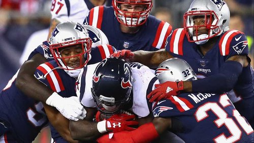 Lamar Miller of the Houston Texans is tackled by four Patriots