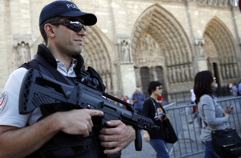 A French police officer patrols in front of Notre Dame cathedral in Paris Friday Sept. 9 2016. A failed attack involving a car loaded with gas canisters near Notre Dame Cathedral was spearheaded a group of women that included a 19-year-old whose writte