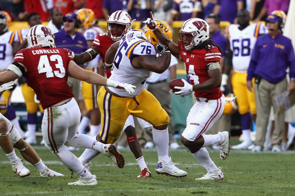 GREEN BAY WI- SEPTEMBER 03 Josh Boutte #76 of the LSU Tigers delivers a late hit against D'Cota Dixon #14 of the Wisconsin Badgers after Dixon intercepted a pass during the fourth quarter at Lambeau Field