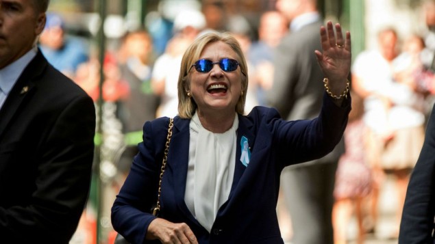 Democratic presidential candidate Hillary Clinton waves after leaving an apartment building Sunday