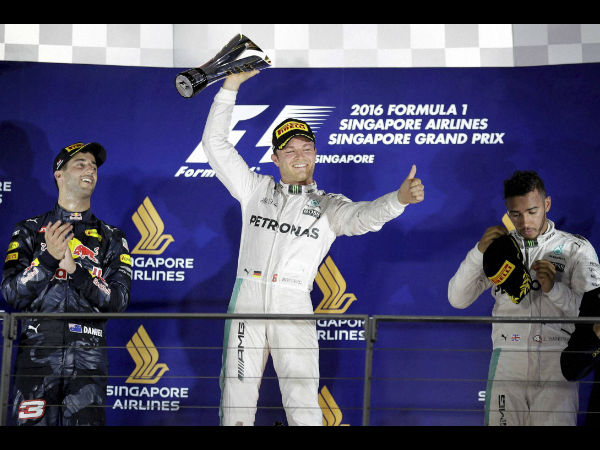 Mercedes driver Nico Rosberg of Germany celebrates after winning the Singapore Formula One Grand Prix on the Marina Bay City Circuit Singapore Sunday Sept. 18