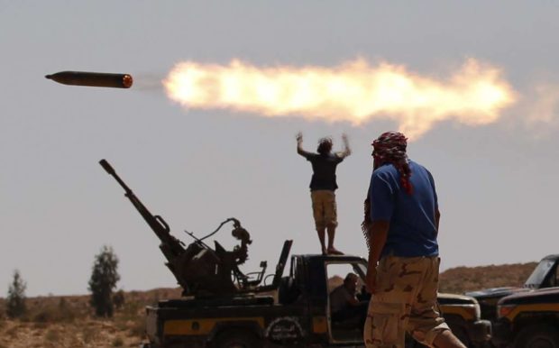 Fighters fire a multiple rocket launcher near Sirte Libya. REUTERS  Goran Tomasevic