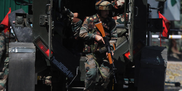 LightRocket via Getty Images                       Army soldiers arrive near the army Brigade HQs which was attacked by militant in the border town of Uri