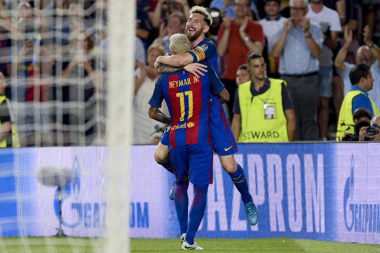 Barcelona's Argentinian forward Lionel Messi celebrates a goal with teammate Barcelona's Brazilian forward Neymar during the UEFA Champions League football match FC Barcelona vs Celtic FC at the Camp Nou stadium in Barcelona on September 13