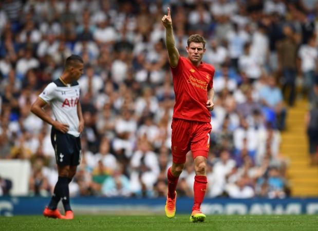 Liverpool's James Milner celebrates scoring their first goal as Tottenham's Erik Lamela looks on dejected during the matchReuters