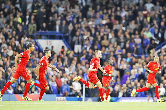 Liverpool’s Jordan Henderson celebrates after scoring his side’s second goal during the English Premier League soccer match between Chelsea and Liverpool at Stamford Bridge.- AP