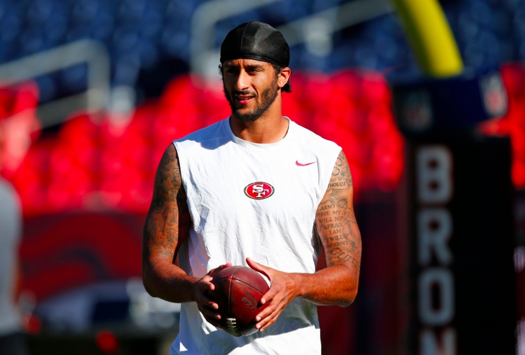 San Francisco 49ers quarterback Colin Kaepernick holds the football during warmups before a preseason NFL football game against the Denver Broncos Saturday Aug. 20 2016 in Denver