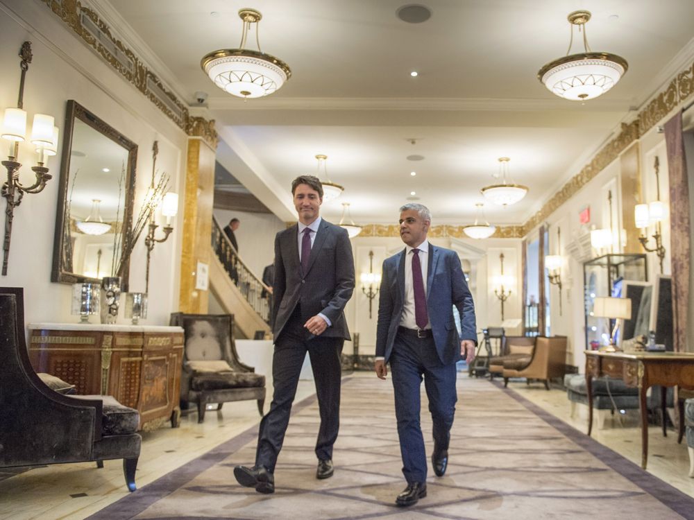 Prime Minister Justin Trudeau left and London Mayor Sadiq Khan walk down the hall of the Ritz hotel at the Global Progress conference Thursday