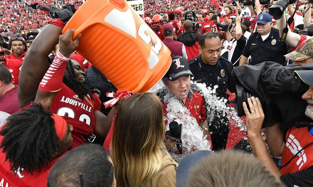 Louisville head coch Bobby Petrino gets the doused following Louisville's 63-20 victory over Florida State in an NCAA college football game Saturday Sep. 17 2016 in Louisville Ky