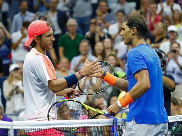 Lucas Pouille shakes hands with Rafael Nadal after their US Open Men's Singles match in New York