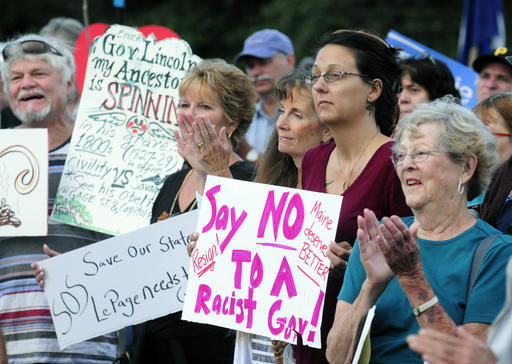 People clap during speeches at a rally to protest recent remarks by Maine Gov. Paul Le Page in Capital Park in Augusta Maine Tuesday Aug. 30 2016. Amid political pressure and calls for his resignation Repub