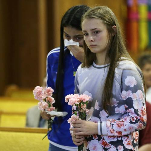 15 right and Selena Orozco 15 left carry flowers as they attend a prayer service Saturday Sept. 24 2016 at the Central United Methodist Church in Sedro-Woolley Wash. The service was held in regard to Friday's fatal sho